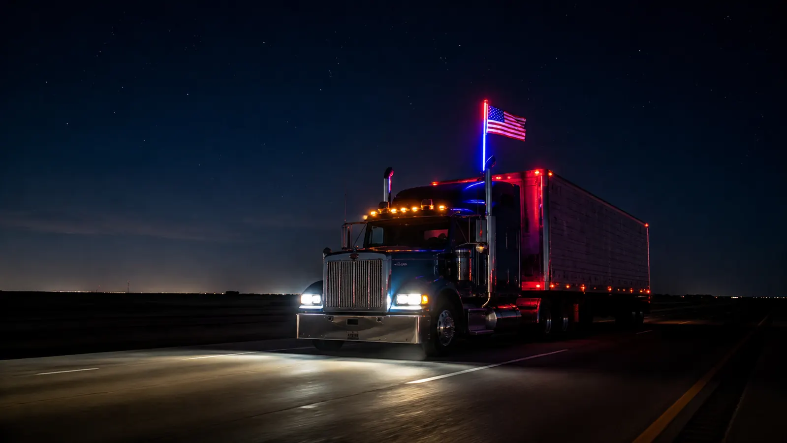 Semi truck cab at night on an empty interstate, an illuminated RGB LED whip light with American flag glowing bright above the cab