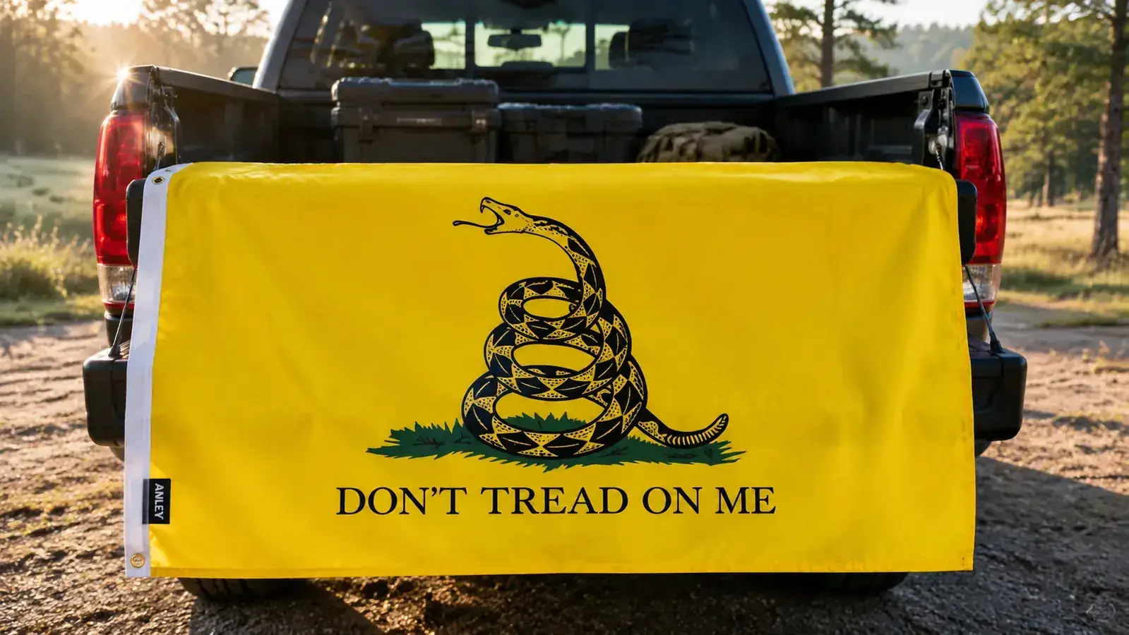 Close-up of a Gadsden flag canvas header and brass grommets on a white background