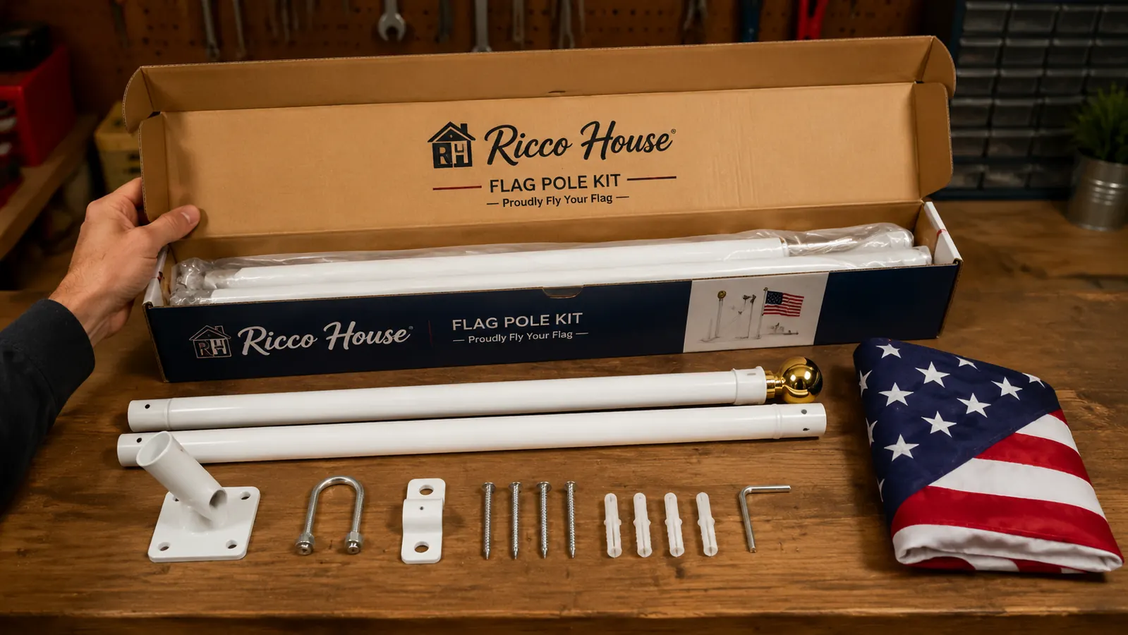 Ricco House flag pole kit components laid out on a rubber truck mat next to a semi trailer hitch