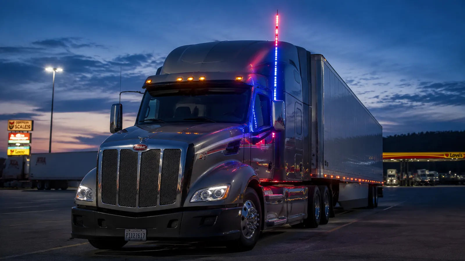 True Mods 4ft RGB LED whip light mounted on a semi truck cab at dusk, glowing red white and blue