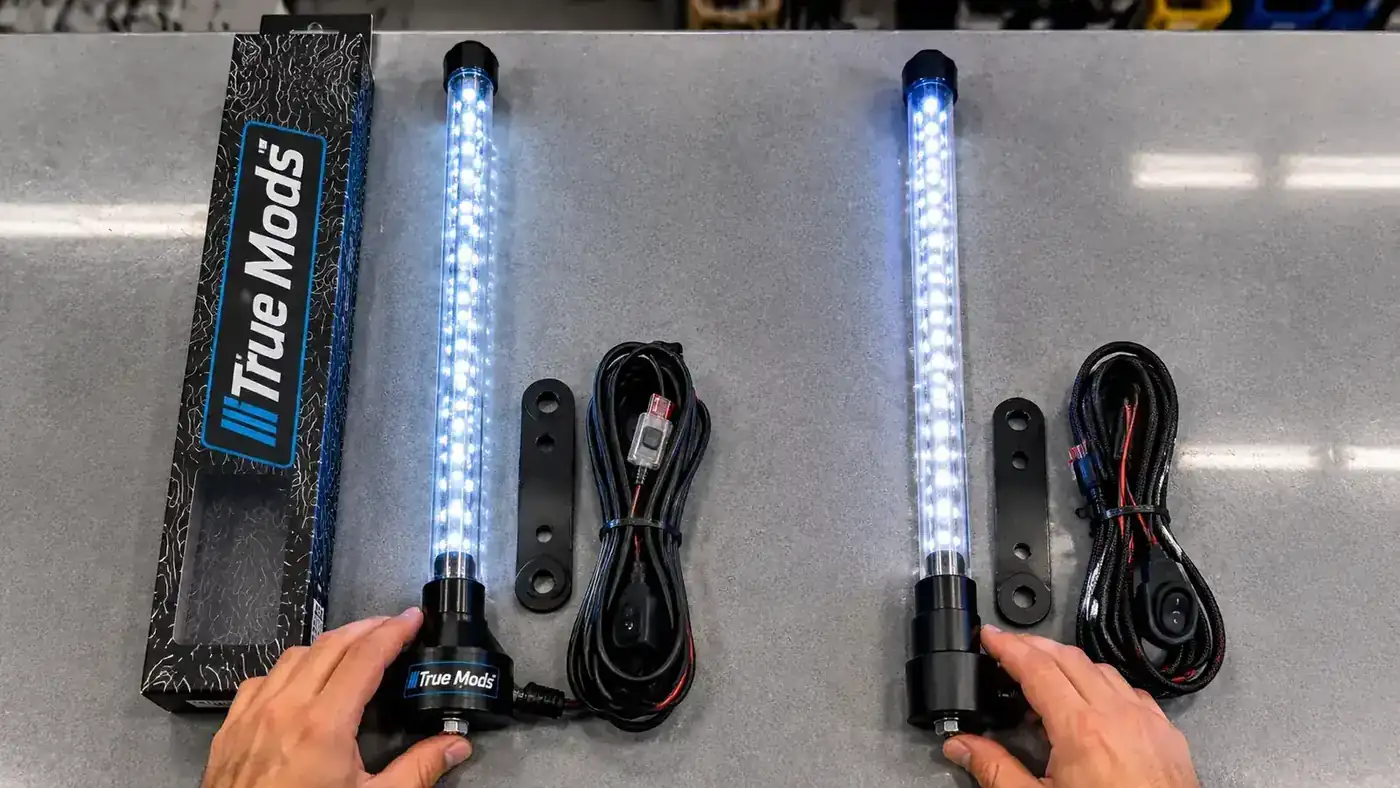 True Mods 4ft RGB LED whip light pole with USA flag attached, lit up in full color